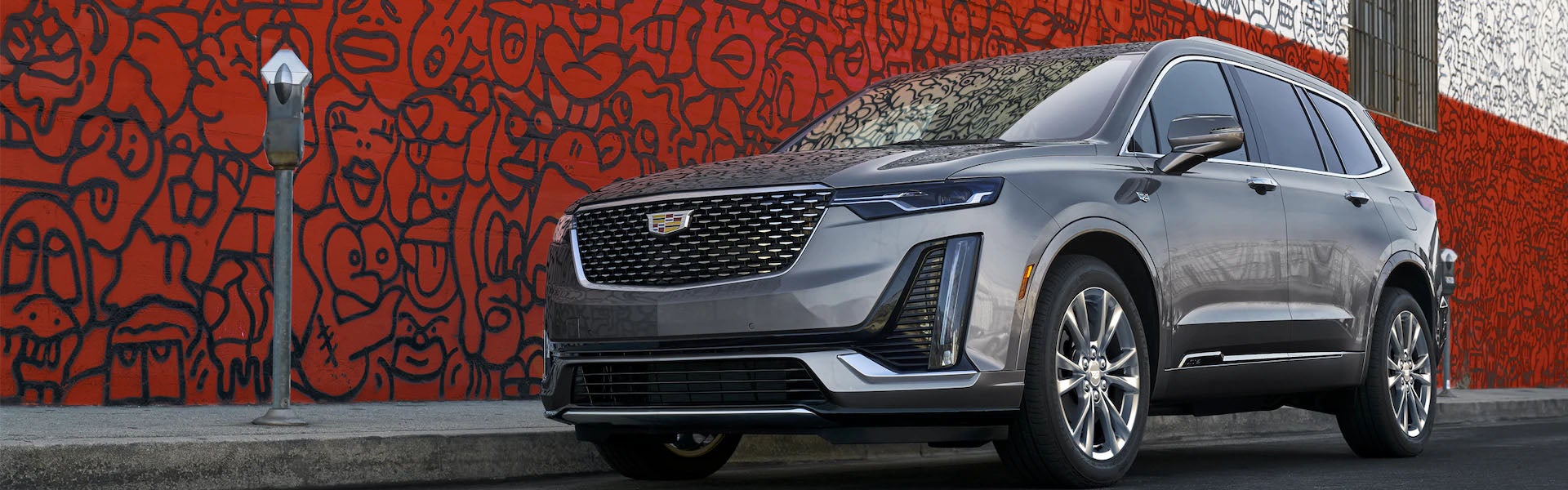 black Cadillac XT6 with red background
