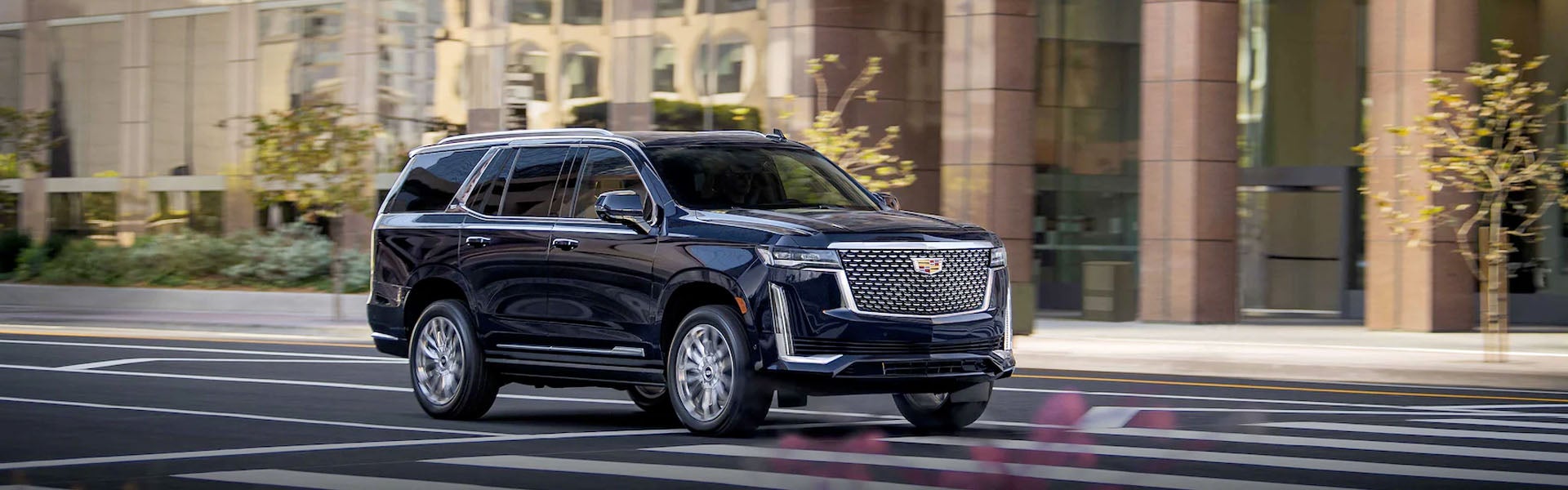 black Cadillac Escalade running on road