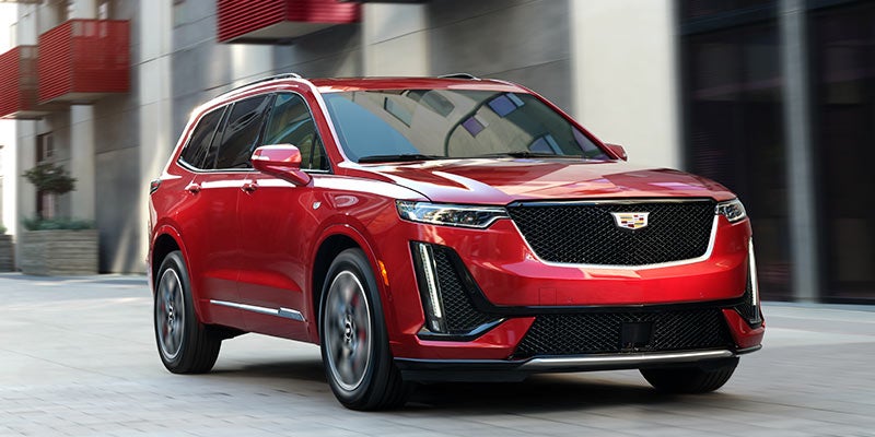 red Cadillac XT6 running on road